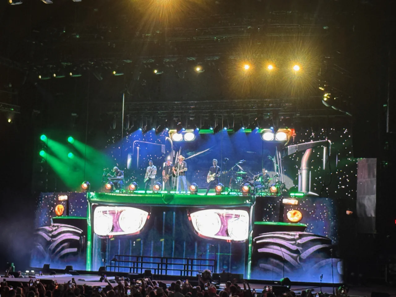 Jason Aldean and band on a stage designed as the illuminated front of a large truck.